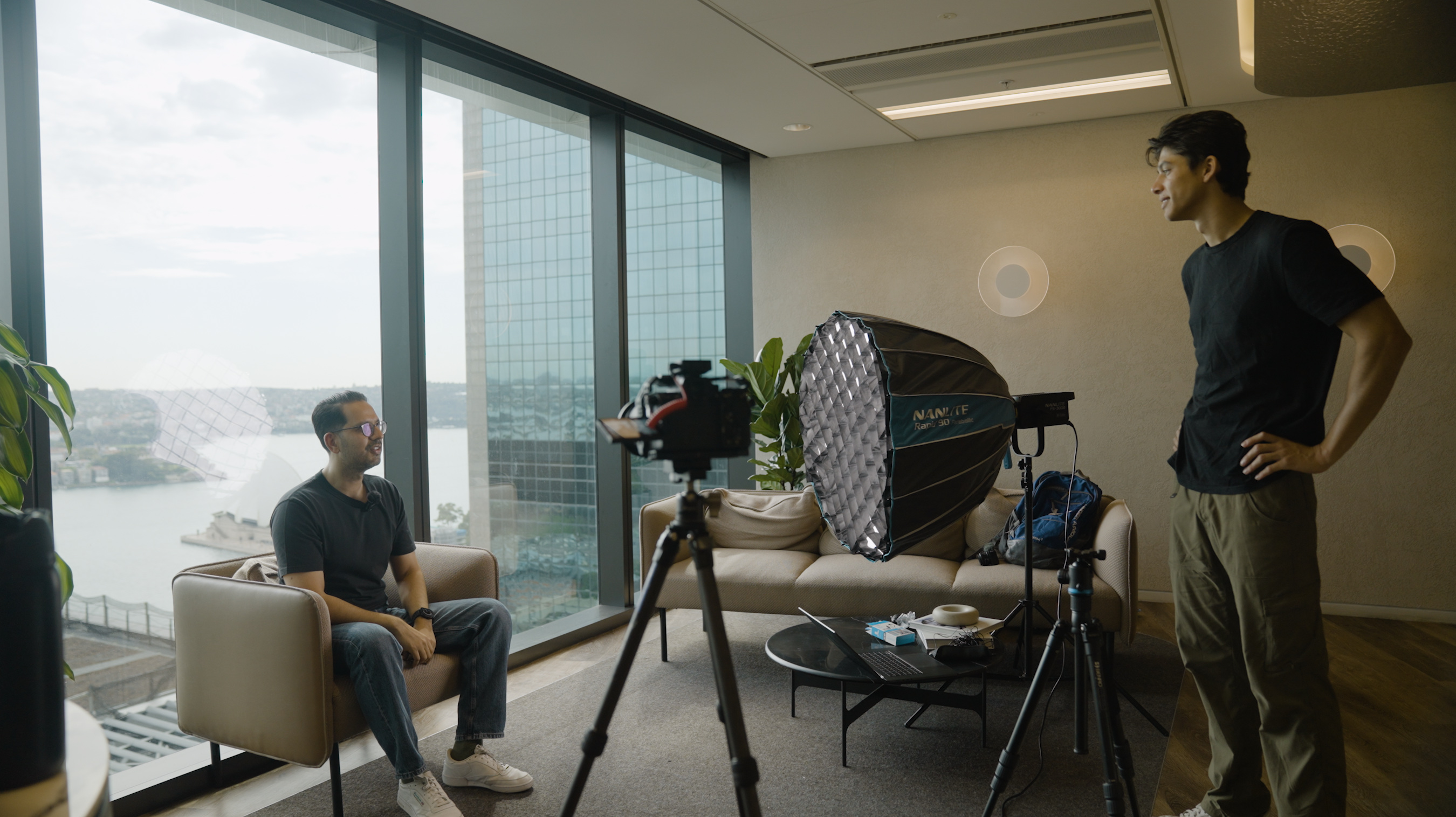 Anikan directing a founder shoot in a Sydney high-rise overlooking the harbour